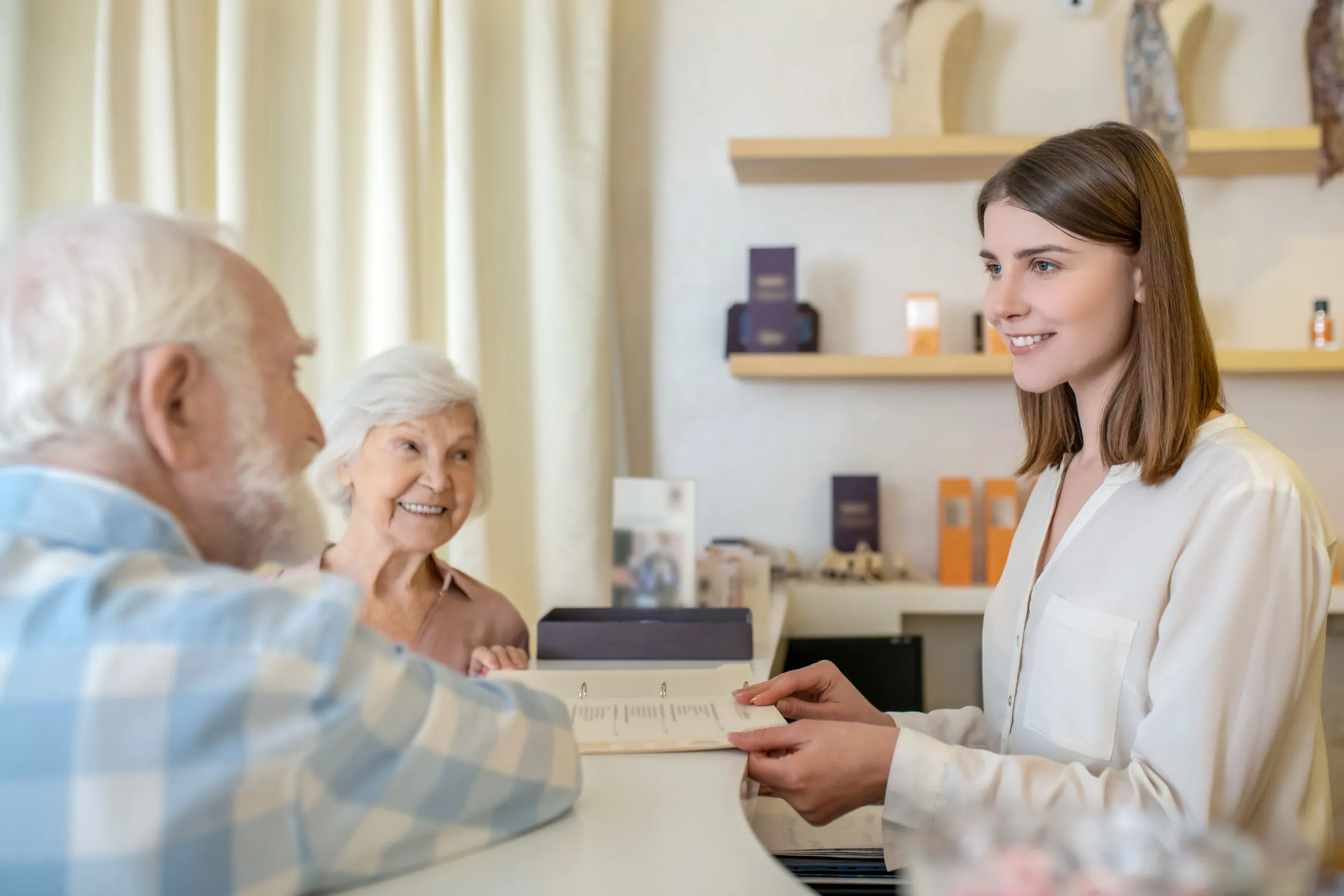 Elderly couple discussing procedures with a specialist in a spa center Elderly couple discussing procedures with a specialist in a spa center